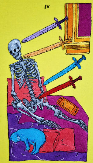 A hand embroidered art piece with a grayscale skeleton on yellow fabric with 4 swords pointed at its head (purple), neck (orange), elbow (blue) and abdomen (red). It is sitting on a fuchsia bed with a purple blanket and pink pillows. A blue cat and an oran